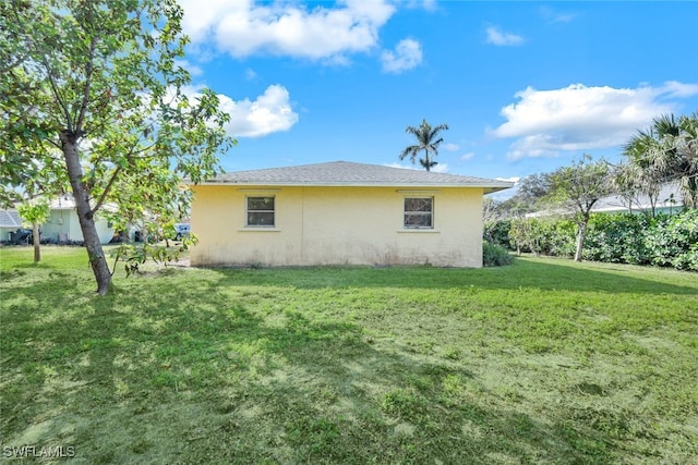 view of side of home featuring a yard