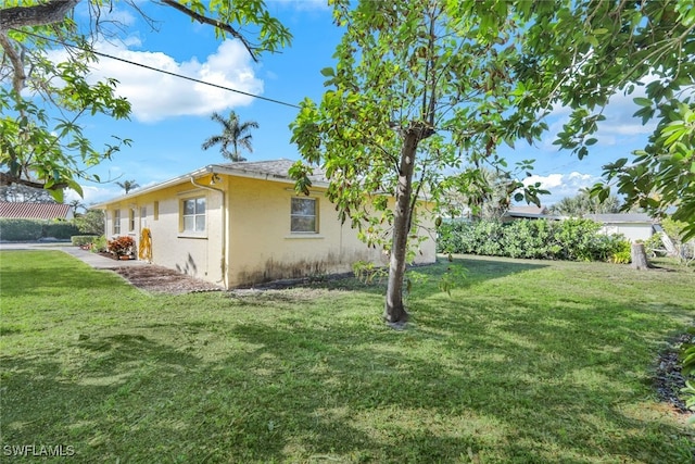 view of property exterior with a yard