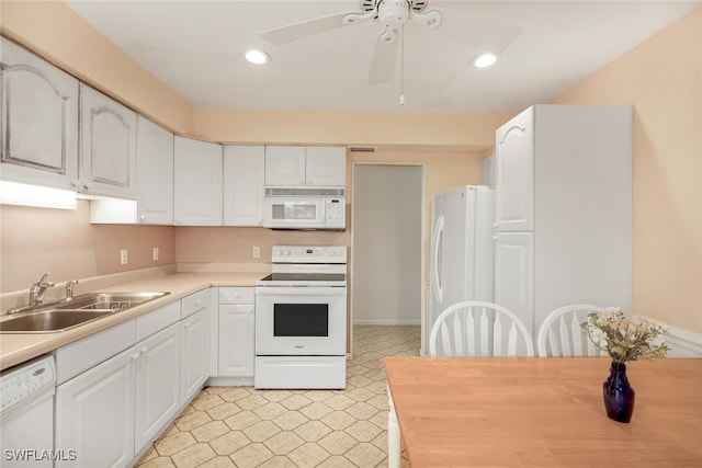 kitchen with white cabinetry, sink, white appliances, and ceiling fan