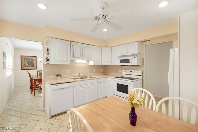 kitchen featuring ceiling fan, sink, white cabinets, and white appliances