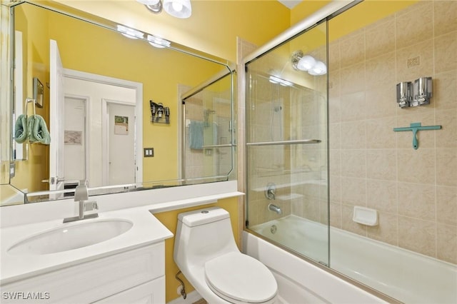 full bathroom with vanity, toilet, and combined bath / shower with glass door