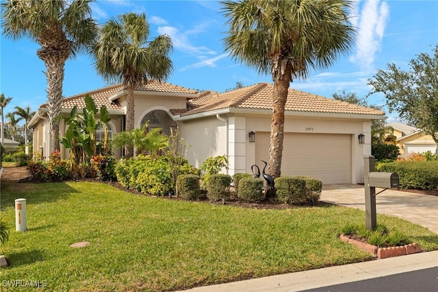 mediterranean / spanish-style home featuring a garage and a front lawn