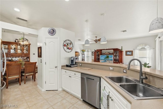 kitchen with hanging light fixtures, white cabinetry, sink, and stainless steel dishwasher