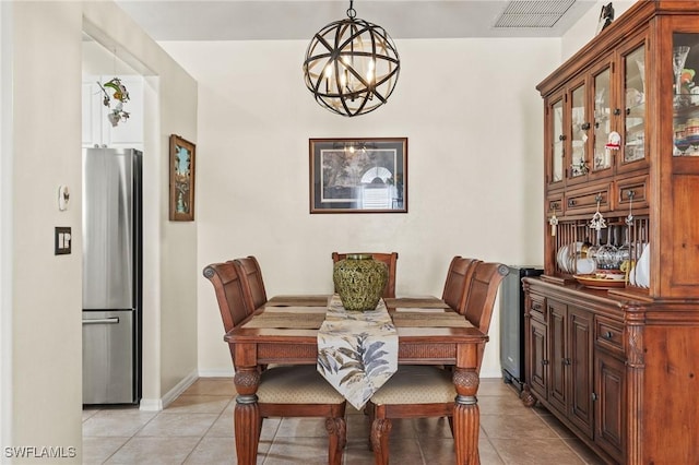 tiled dining space featuring a notable chandelier