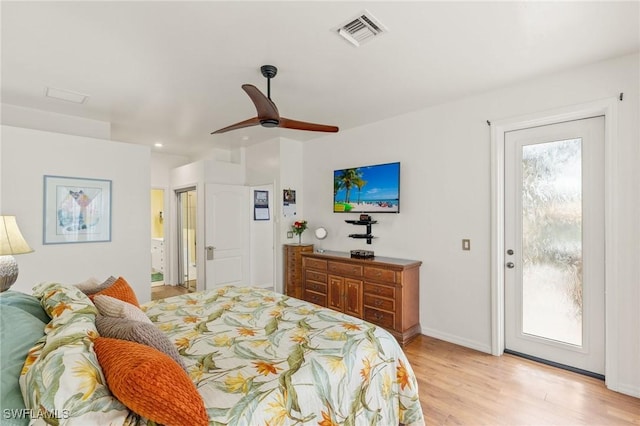 bedroom with multiple windows, access to outside, ceiling fan, and light hardwood / wood-style floors