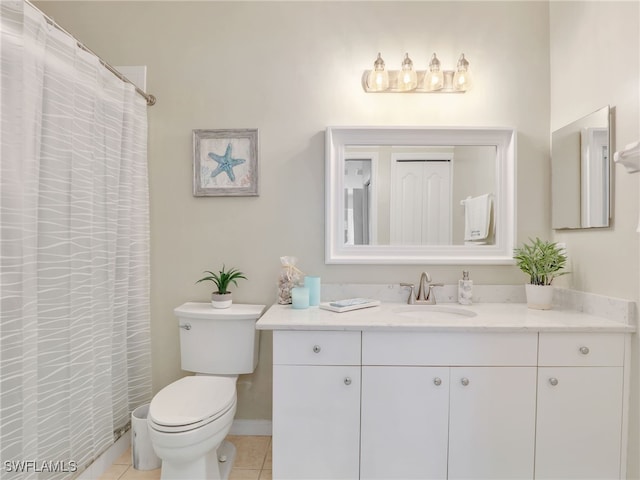 bathroom featuring toilet, vanity, and tile patterned flooring