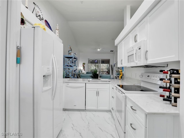 kitchen with ceiling fan, sink, white appliances, and white cabinets