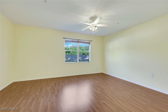 spare room with hardwood / wood-style flooring and ceiling fan