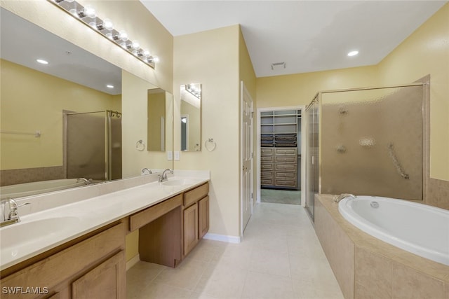 bathroom with independent shower and bath, vanity, and tile patterned flooring