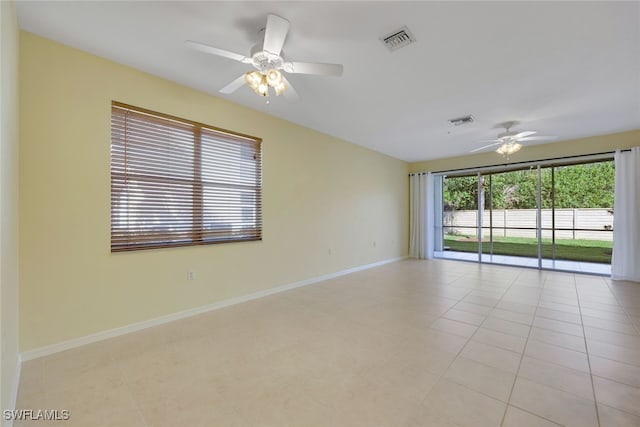 spare room featuring light tile patterned flooring and ceiling fan