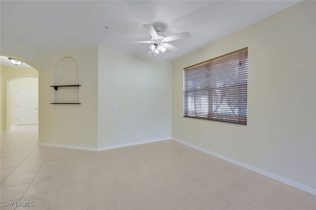 spare room featuring light tile patterned flooring and ceiling fan