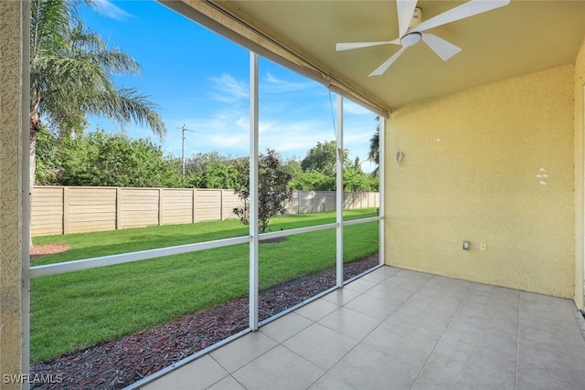 unfurnished sunroom featuring ceiling fan