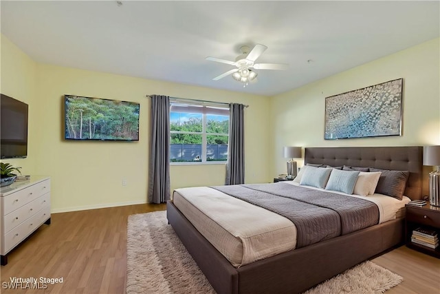 bedroom with ceiling fan and light wood-type flooring