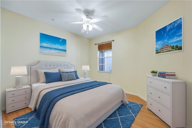 bedroom with light hardwood / wood-style floors and ceiling fan