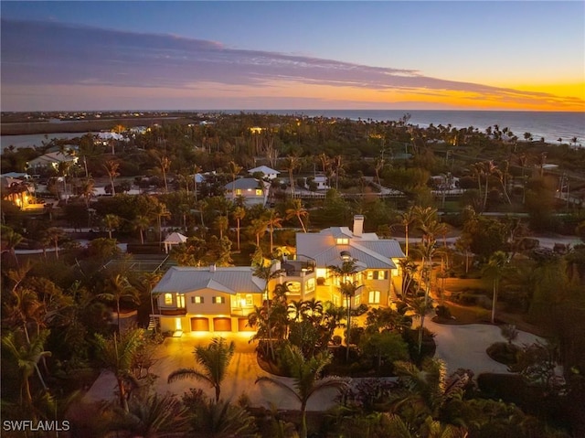 aerial view at dusk with a water view