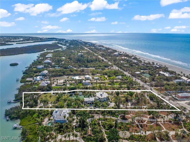 drone / aerial view with a water view and a view of the beach