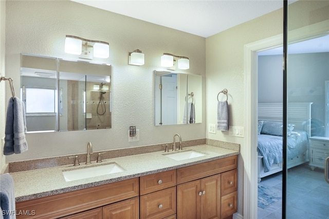 ensuite bathroom featuring double vanity, ensuite bath, a shower, and a sink