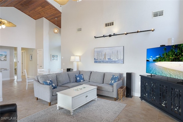 living room with high vaulted ceiling, visible vents, and light tile patterned floors