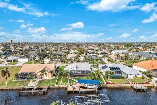 drone / aerial view featuring a residential view and a water view