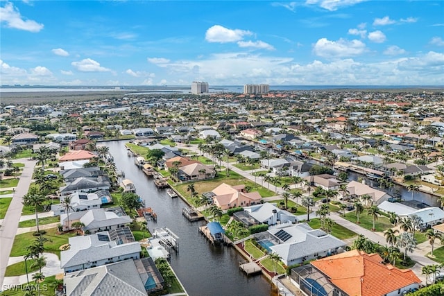 birds eye view of property with a water view and a residential view