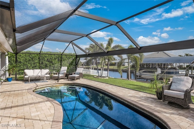 outdoor pool with glass enclosure, an outdoor hangout area, a water view, a yard, and a patio area