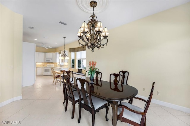 dining space featuring sink, light tile patterned floors, and a chandelier