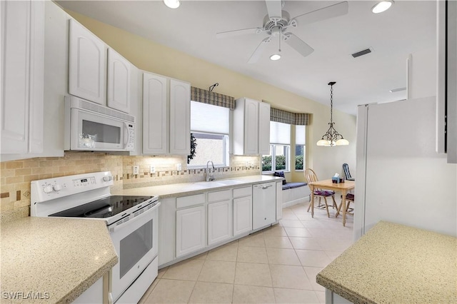 kitchen with white appliances, pendant lighting, white cabinetry, sink, and light tile patterned flooring