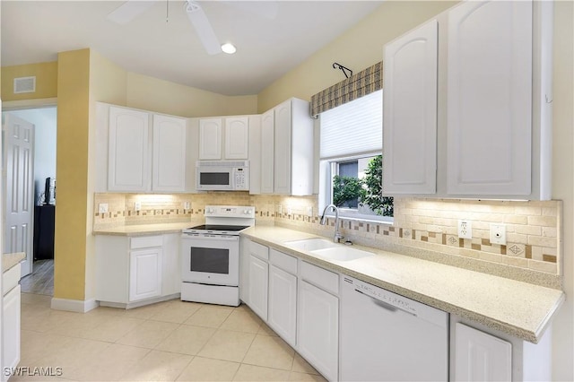 kitchen featuring light tile patterned floors, sink, white appliances, and white cabinets