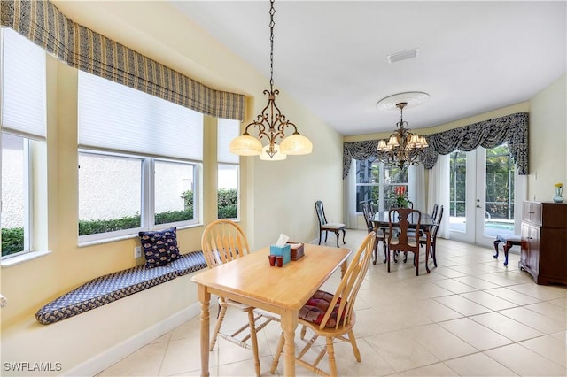 dining area with plenty of natural light, light tile patterned floors, and french doors