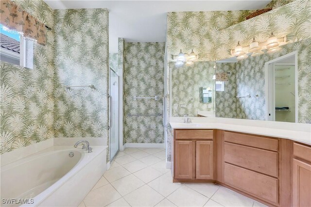 bathroom with a bath, vanity, and tile patterned flooring