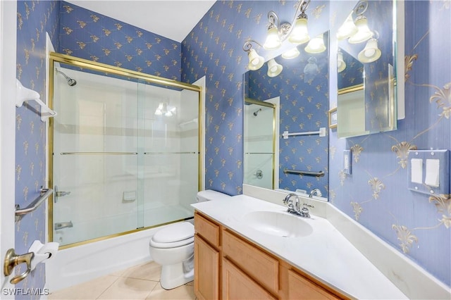 full bathroom featuring enclosed tub / shower combo, vanity, toilet, and tile patterned flooring