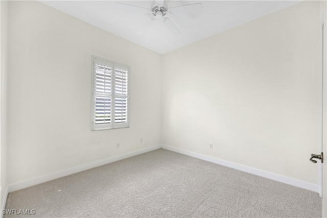 carpeted spare room with ceiling fan