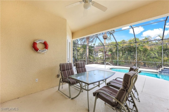 sunroom / solarium featuring ceiling fan