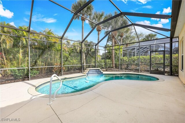 view of pool with a patio and a lanai