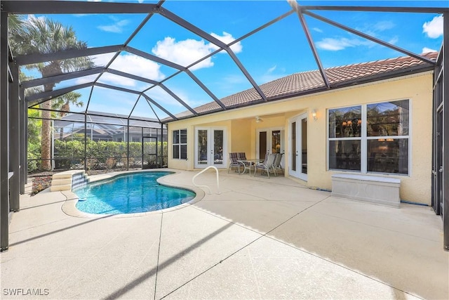 view of swimming pool featuring ceiling fan, a lanai, french doors, and a patio