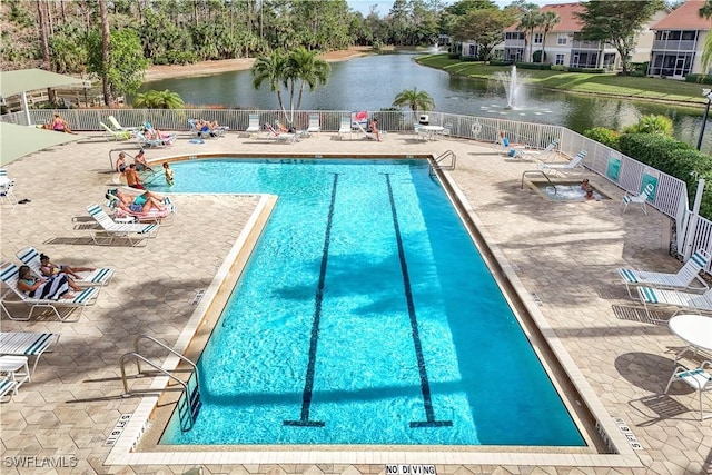 view of swimming pool featuring a water view and a patio