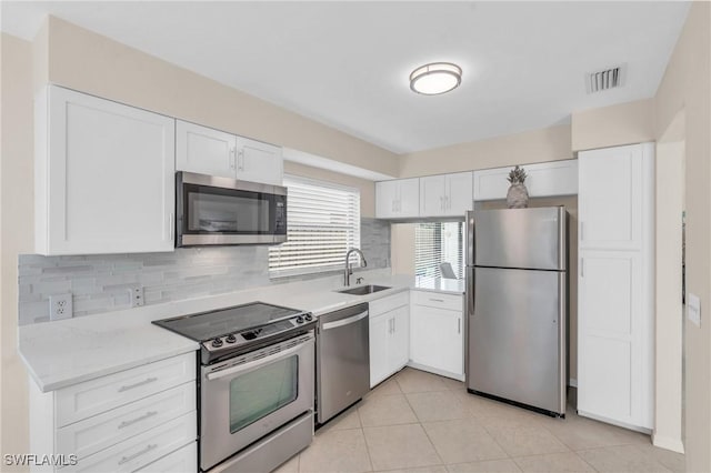833 Reef Point Cir, Naples, FL 34108 - kitchen with backsplash, sink, white cabinetry, and appliances with stainless steel finishes