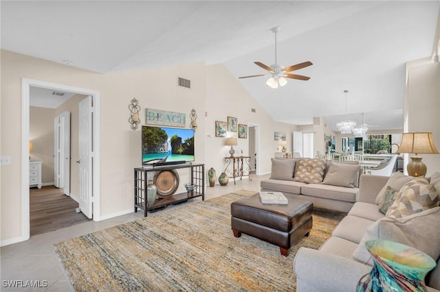 833 Reef Point Cir, Naples, FL 34108 - living room featuring light tile patterned flooring, ceiling fan with notable chandelier, and high vaulted ceiling