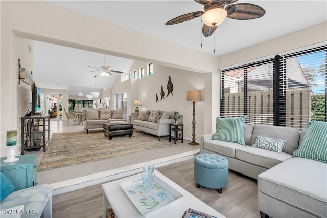 833 Reef Point Cir, Naples, FL 34108 - living room with light wood-type flooring, ceiling fan with notable chandelier, and lofted ceiling