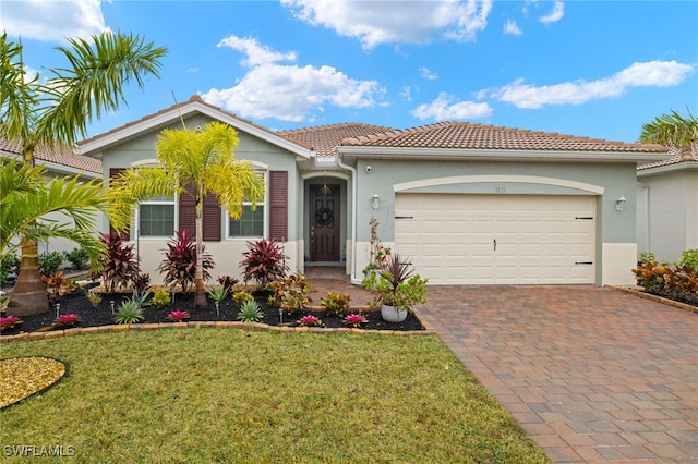 mediterranean / spanish house with a garage and a front yard