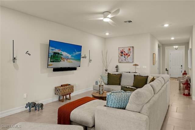 tiled living room with ceiling fan