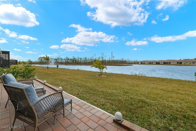 view of yard with a water view and a patio area