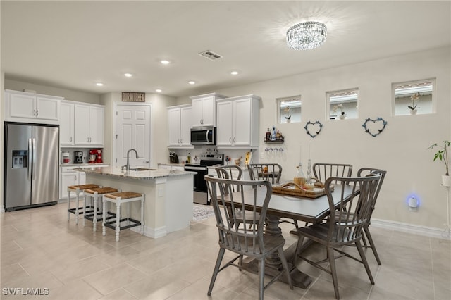 tiled dining space featuring sink