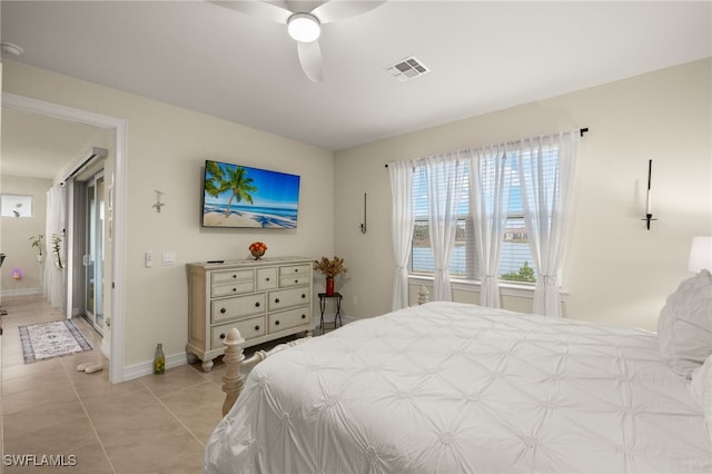 tiled bedroom featuring ceiling fan