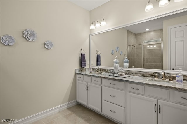 bathroom with tile patterned flooring, vanity, and walk in shower