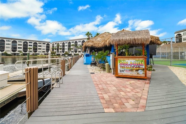 surrounding community featuring a gazebo, a water view, and a dock