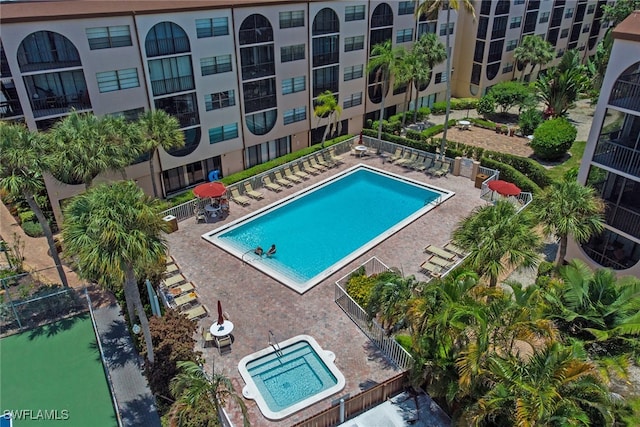 view of swimming pool with a community hot tub and a patio area