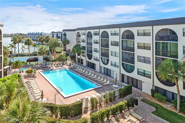 view of pool featuring a patio and a water view