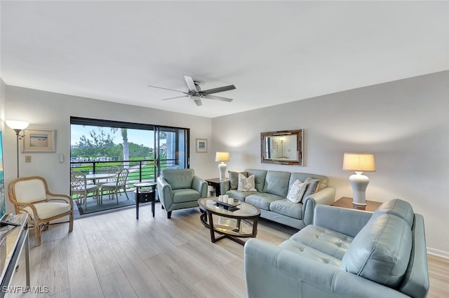 living room featuring ceiling fan and light hardwood / wood-style floors