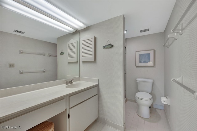 bathroom with vanity, toilet, and tile patterned flooring